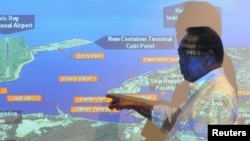 FILE - Subic Bay Metropolitan Authority (SBMA) chairman Roberto Garcia points at a map of Subic Bay during a forum in Subic Bay, Zambales province, north of Manila, Sept. 25, 2015.