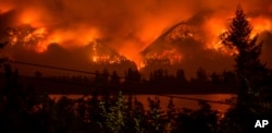 FILE - The Eagle Creek Fire, as seen from near Stevenson Wash., across the Columbia River, burns in the Columbia River Gorge above Cascade Locks, Ore., Sept. 4, 2017.