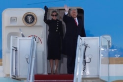 President Donald Trump and first lady Melania Trump wave to a crowd as they board Air Force One at Andrews Air Force Base, Md., Wednesday, Jan. 20, 2021.
