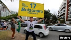 A supporter of presidential candidate Jair Bolsonaro is seen in front of Bolsonaro's condominium at Barra da Tijuca neighborhood in Rio de Janeiro, Brazil,, Oct. 4, 2018.