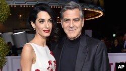 FILE - Amal Clooney, left, and George Clooney arrive at the world premiere of "Hail, Caesar!" in Los Angeles. 