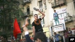 An Egyptian protester chants slogans against the country's military ruling council and presidential candidate Ahmed Shafiq in Tahrir Square in Cairo, Egypt, June 14, 2012.