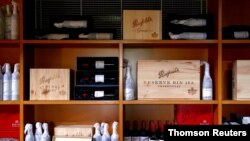 FILE - Bottles of Penfolds Grange wine and other varieties, made by Australian wine maker Penfolds and owned by Australia's Treasury Wine Estates, sit on shelves for sale