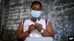 A nurse prepares to administer a coronavirus vaccination at Kisenyi Health Center in downtown Kampala, Uganda Wednesday, Sept. 8, 2021. Uganda is accelerating its vaccination drive in order to administer 128,000 doses that recently arrived and…