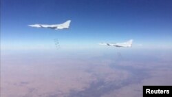 A still image taken from a video footage and released by Russia's Defence Ministry on January 24, 2017, shows Russian Tupolev Tu-22M3 long-range bombers dropping off bombs on what Defense Ministry said Islamic State targets in Deir al-Zor province, Syria.