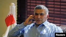 FILE - Bahrain human rights activist Nabeel Rajab is seen talking on his mobile phone.