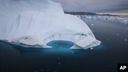 FILE - An iceberg is seen melting off the coast of Ammasalik, Greenland, July 19, 2007.