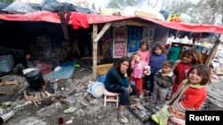 Syrian refugee children gather around fire near makeshift tents, central Ankara, Oct. 5, 2013.