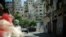 Lebanese army armored vehicles idle on Syria Street between the Jebel Mohsen and Bab Tabbaneh neighborhoods of Tripoli, Lebanon, August 23, 2012. (VOA/Jeff Neumann)