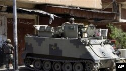 Soldiers deployed at Syria street, which divides Sunni and Alawite areas of Tripoli, Lebanon, June 3, 2012.