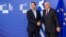 European Commission President Jean-Claude Juncker, right, welcomes Greece's Prime Minister Alexis Tsipras upon his arrival at the European Commission headquarters in Brussels, Feb. 4, 2015. 