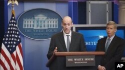 Nuclear Regulatory Commission Chairman Gregory Jaczko, left, accompanied by Deputy Energy Secretary Dan Poneman, briefs reporters at the White House regarding nuclear concerns following Japan's earthquake and tsunami, March 14, 2011