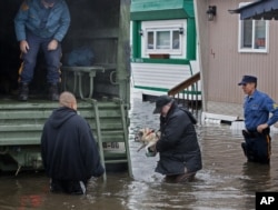 A man walks with his dog to a National Guard vehicle after leaving his flooded home in Moonachie, New Jersey, after Hurricane Sandy on Oct. 30, 2012.