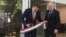 Hungarian State Secretary for Economic Strategy László György, left, cuts a ribbon as Ambassador László Szabó looks on at the opening ceremony of a business promotion center in Washington in May 2019.