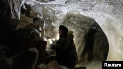 Sergey Zimov, 66, a scientist who works at Russia's Northeast Science Station, checks materials stored underground in the permafrost at the Pleistocene Park outside the town of Chersky, Sakha (Yakutia) Republic, Russia, September 13, 2021. (REUTERS/Maxim Shemetov/File Photo)