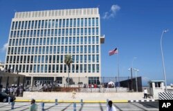 FILE - A U.S. flag flies at the U.S. embassy in Havana, Cuba, Aug. 14, 2015. U.S. investigators are chasing many theories about what harmed American diplomats in Cuba.