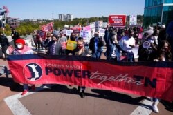 People take part in a Power Together Women's March, Oct. 17, 2020, in Nashville, Tenn. Dozens of women's rallies were planned across the U.S. to signal opposition to President Donald Trump and his policies.