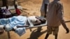 FILE - A man with a gunshot wound in his leg is carried by stretcher inside the Juba Military Hospital in Juba, South Sudan, Dec. 28, 2013. 