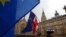 Anti Brexit demonstrators hold up their flags opposite the Houses of Parliament in London, April 3, 2019.