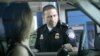 FILE - U.S. Customs and Border Protection officer Kevin Corsaro speaks with an unidentified motorist entering the United States from Canada at the border in Buffalo, N.Y.