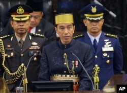 FILE - Indonesia's President Joko Widodo, center, delivers his State of The Nation address ahead of the country's Independence Day at the parliament building in Jakarta, Indonesia, Aug. 16, 2017.