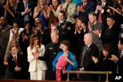 Albuquerque Police Officer Ryan Holets and his wife Rebecca acknowledge their introduction by President Donald Trump as they stand with first lady Melania Trump during the State of the Union address