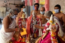 Hindu priests wearing face masks perform rituals during the Ram Navami festival at a temple closed for devotees as part of lockdown to curb the spread of new coronavirus in Hyderabad, India, April 2, 2020.