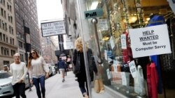 FILE - A "Help Wanted" sign hangs in a store window in New York City, Oct. 1, 2015.
