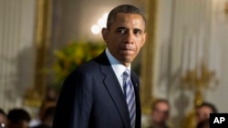 FILE - President Barack Obama arrives in State Dining Room of the White House, June 14, 2013.
