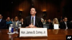 FILE - FBI Director James Comey prepares to testify on Capitol Hill in Washington, May 3, 2017.