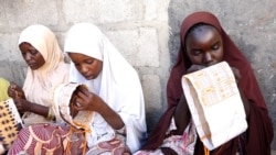 Girls and women embroider caps and other items to sell from Kawar Maila, an informal camp in Maiduguri, Nigeria. (Haruna Shehu/VOA)