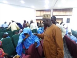 A freed student of Salihu Tanko Islamic School reunites with her father in Minna, Nigeria, Aug 27, 2021.