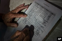 A man signs a petition during a campaign to collect signatures against the interference of the United States in the internal politics of Venezuela in Caracas, Venezuela, Feb. 9, 2019.