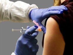 Healthy volunteer receives injection in the first-stage safety study clinical trial of a potential vaccine for COVID-19, Kaiser Permanente Washington Health Research Institute, Seattle, Washington.