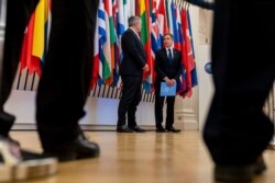 US Secretary of State Antony Blinken, right, accompanied by Secretary-General of the Organization for Economic Cooperation and Development (OECD) Mathias Cormann, of Australia, speaks at the OECD headquarters in Paris, June 25, 2021.
