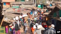 FILE - Rohingya refugees walk at the Balukhali refugee camp in Cox's Bazar, Bangladesh, Feb.2, 2021.