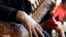 FILE - In this Jan. 7, 2013 file photo, an Afghan girl practices playing the sitar in a class at the Afghan National Institute of Music, ANIM, in Kabul, Afghanistan. 