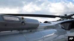 In this photo released by Colombia's Presidency, bullet holes dot the fuselage of a Colombian Air Force helicopter that that came under attack while President Ivan Duque and members of his Cabinet were traveling in it June 25, 2021.