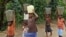 FILE - Children accused of witchcraft carrying water at the Children's Rights and Rehabilitation Network in Eket, Nigeria.