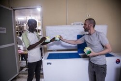 Eduardo Martins (R) oversees quality assurance operations in South Sudan for Continental Medical Supplies. (Chika Oduah/VOA)