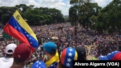 Opponents of President Nicolas Maduro wave a Venezuelan national flag as thousands gather in Caracas, Venezuela, May 20, 2017. Tens of thousands of demonstrators took to the streets again in what has been two months of near-daily street protests. 