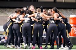 Ottawa University women's flag football team cheers before an NAIA flag football game against Midland University in Ottawa, Kan., March 26, 2021.