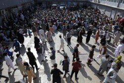 Afghans wait inside the passport office in Kabul, Afghanistan, June 30, 2021.