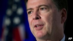 FILE - FBI Director James Comey speaks during the Intelligence and National Security Alliance Leadership Dinner in Alexandria, Va.