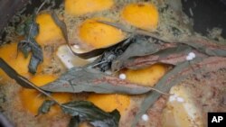 FILE - A batch of lemons, ginger, eucalyptus and aspirin simmer for a tea that some believe serves as protection against the new coronavirus, Santiago, Chile, Wednesday, July 1, 2020.