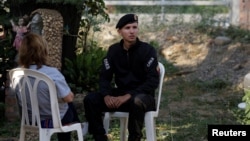 A Venezuelan National Police, member of the Special Tasks Force, is seen at a Colombia Migration office after defecting, in Cucuta, Colombia, Feb. 24, 2019.