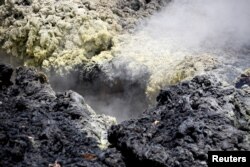 Volcanic gases rise from a fissure in the Leilani Estates subdivision during ongoing eruptions of the Kilauea Volcano in Hawaii, May 14, 2018.