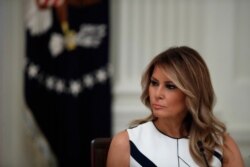 First lady Melania Trump listens as President Donald Trump speaks during a "National Dialogue on Safely Reopening America's Schools" event in the East Room of the White House, July 7, 2020.