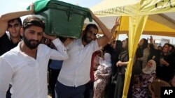 People carry a victim's coffin as they attend funeral services for dozens of people killed in last night's bomb attack targeting an outdoor wedding party in Gaziantep, southeastern Turkey, Aug. 21, 2016. 
