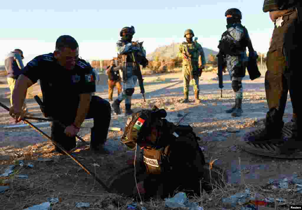 Mexican authorities inspect a culvert that they believe is used by people to illegally cross into the United States from Mexico, in Ciudad Juarez on February 4, 2025.